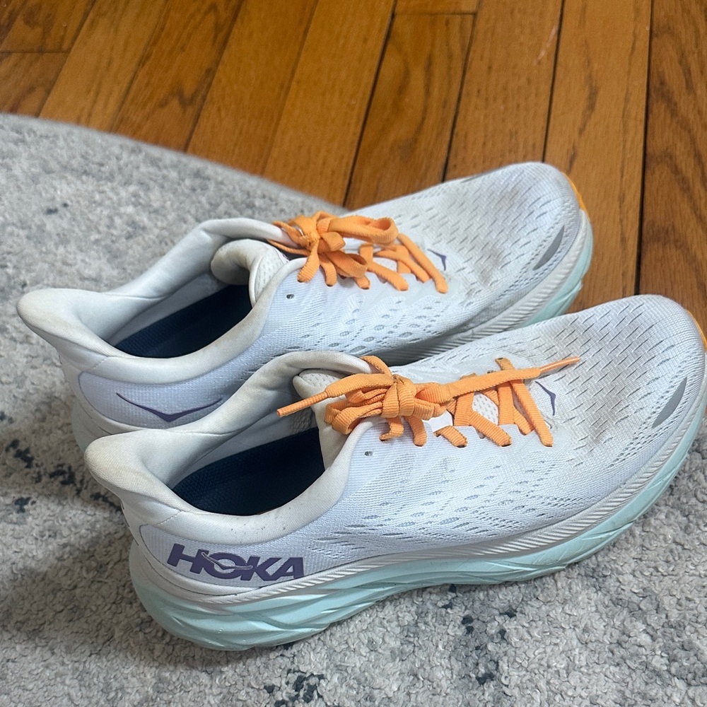 Hoka Clifton 8 white running shoes with mint sole and orange laces